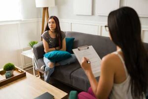 Teen talks to therapist about PTSD treatment