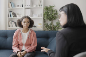 Teen sits on couch and asks therapist "what should I talk about in therapy?"